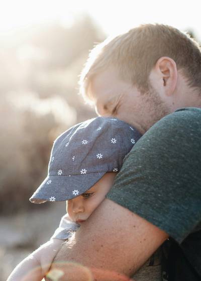 Father holding a young child.
